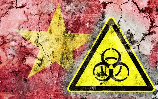 Old cracked wall with biohazard warning sign and painted flag — Stock Photo, Image