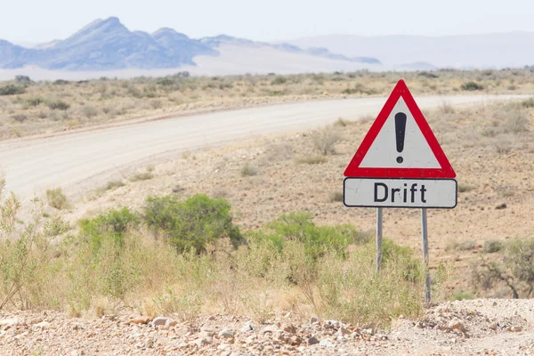 Drift warning sign at a gravel road — Stock Photo, Image