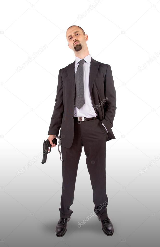 Businessman in handcuffs with pistol in hand