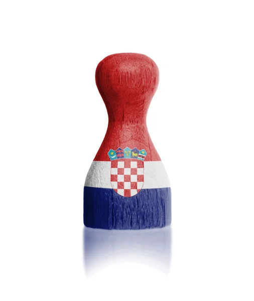 Wooden pawn with a painting of a flag — Stock Photo, Image