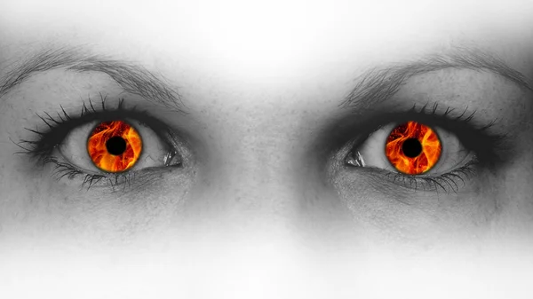 Detail view of female eyes with flames — Stock Photo, Image