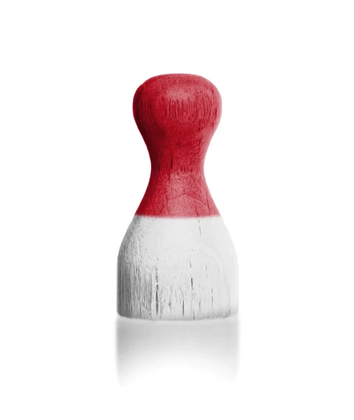 Wooden pawn with a painting of a flag — Stock Photo, Image