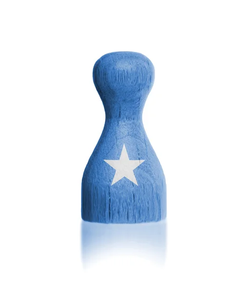 Wooden pawn with a painting of a flag — Stock Photo, Image