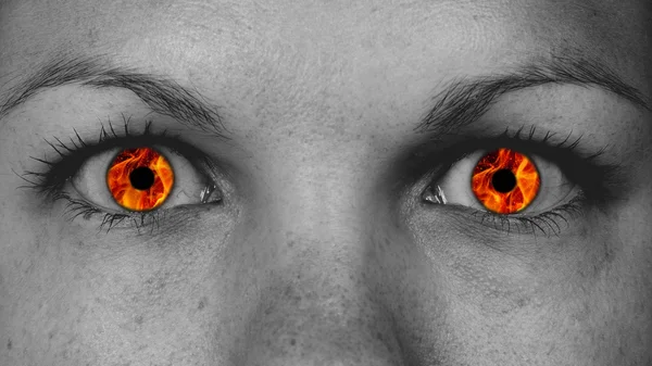 Detail view of female eyes with flames — Stock Photo, Image