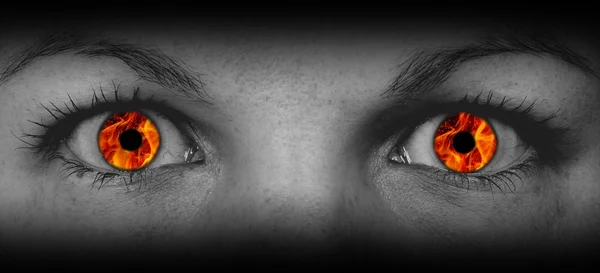 Detail view of female eyes with flames — Stock Photo, Image