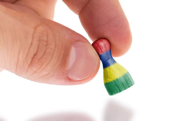 Wooden pawn with a painting of a flag — Stock Photo, Image