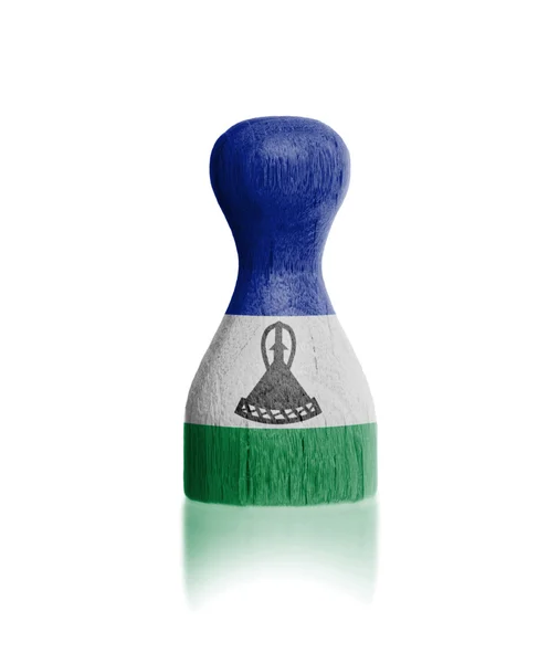 Wooden pawn with a flag painting — Stock Photo, Image