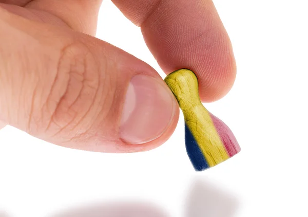 Hand holding wooden pawn, flag painting, selective focus — Stock Photo, Image