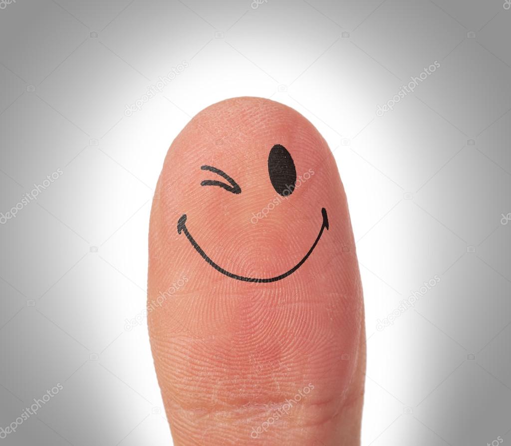Female thumbs with smile face on the finger