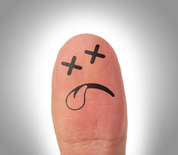 Kvinnliga tummen med leende ansikte på fingret — Stockfoto