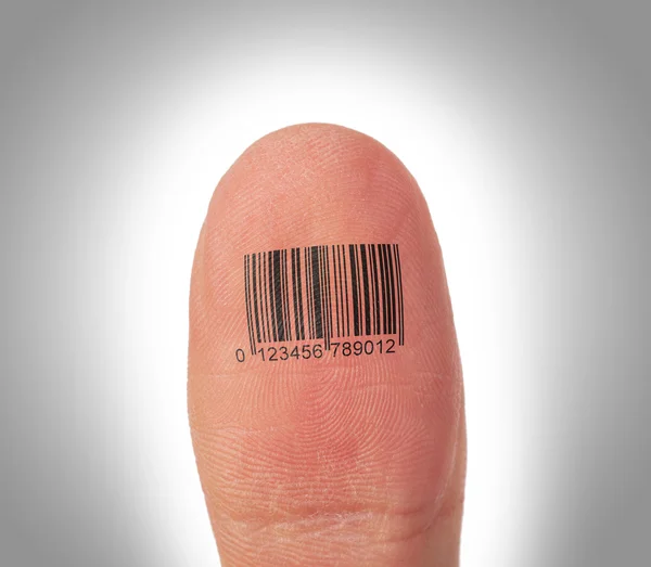 Thumb finger over a white background, barcode — Stock Photo, Image