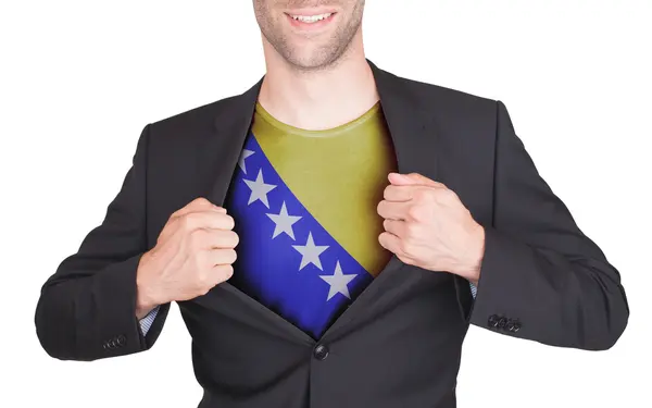 Businessman opening suit to reveal shirt with flag — Stock Photo, Image