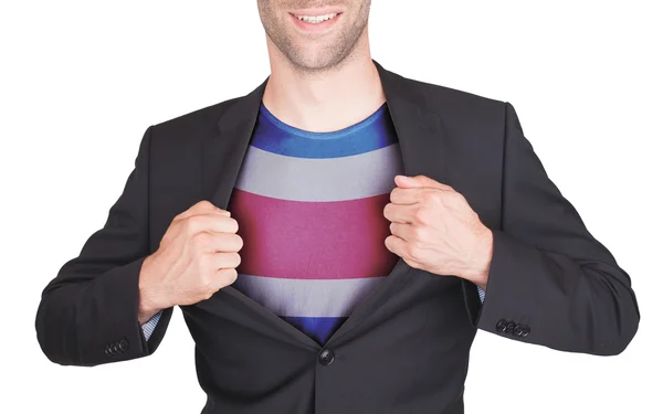 Hombre de negocios abriendo traje para revelar camisa con bandera — Foto de Stock