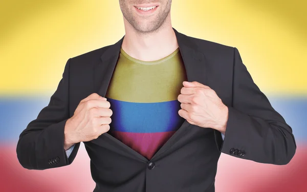 Businessman opening suit to reveal shirt with flag — Stock Photo, Image