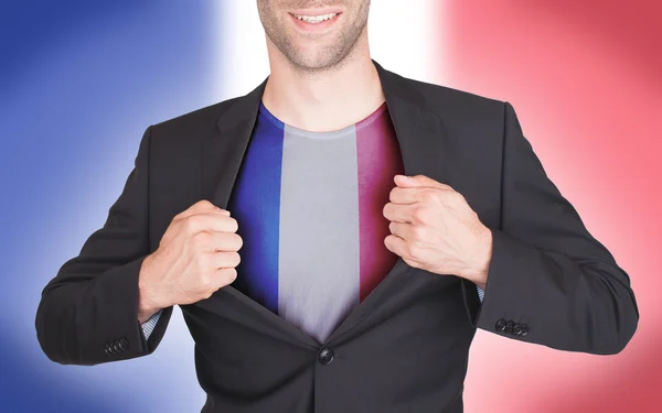 Affärsman öppna kostym att avslöja skjorta med flagga — Stockfoto