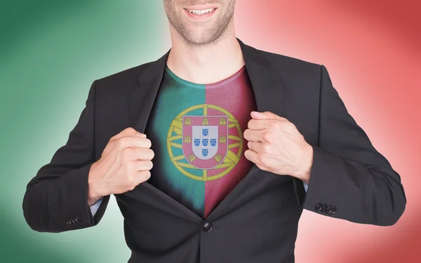 Businessman opening suit to reveal shirt with flag — Stock Photo, Image