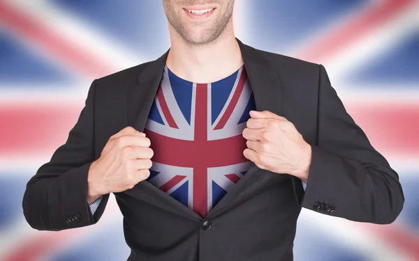 Businessman opening suit to reveal shirt with flag — Stock Photo, Image