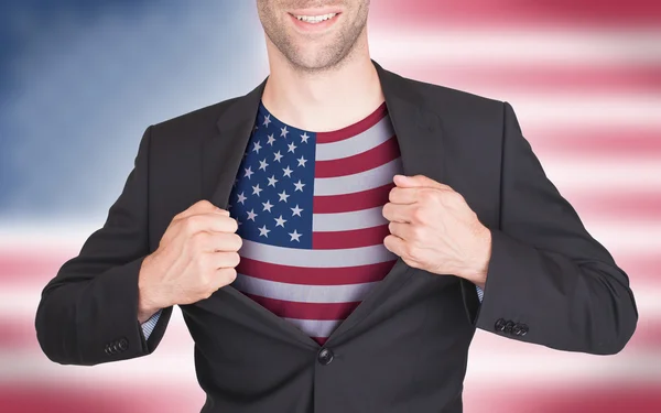 Businessman opening suit to reveal shirt with flag — Stock Photo, Image