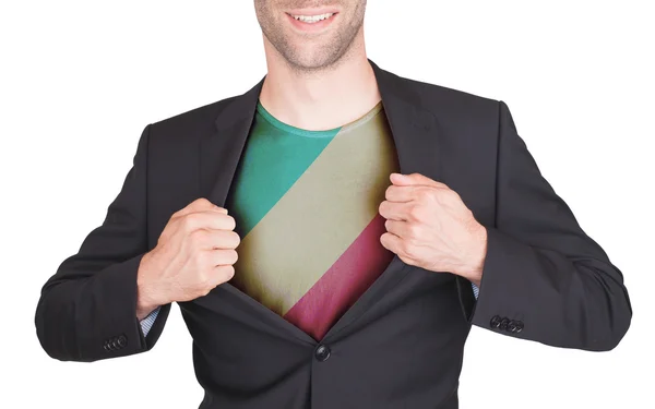 Zakenman opening pak te onthullen shirt met vlag — Stockfoto