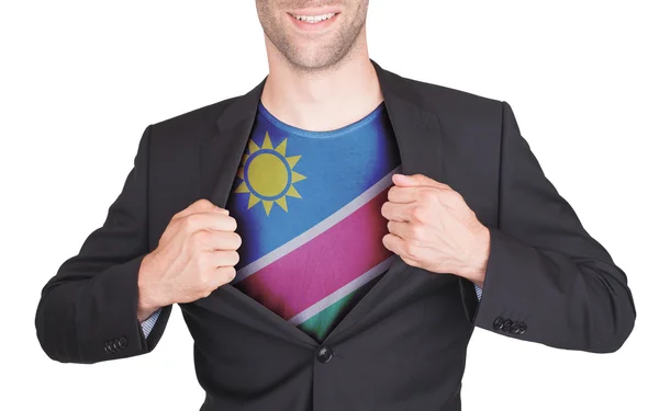 Businessman opening suit to reveal shirt with flag — Stock Photo, Image