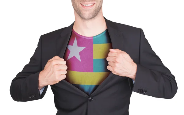 Zakenman opening pak te onthullen shirt met vlag — Stockfoto