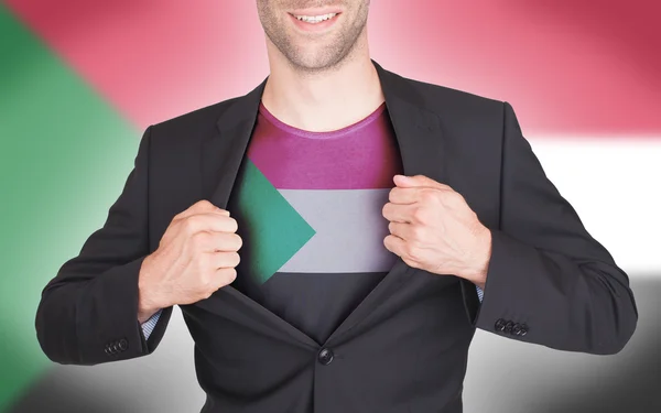 Businessman opening suit to reveal shirt with flag — Stock Photo, Image
