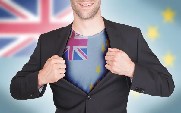 Businessman opening suit to reveal shirt with flag — Stock Photo, Image