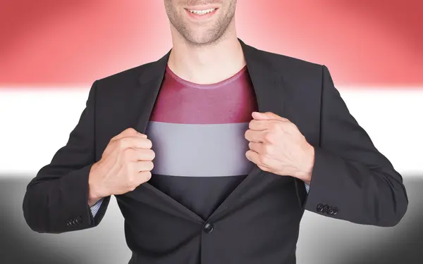 Businessman opening suit to reveal shirt with flag — Stock Photo, Image