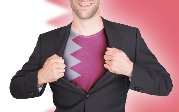 Businessman opening suit to reveal shirt with flag — Stock Photo, Image