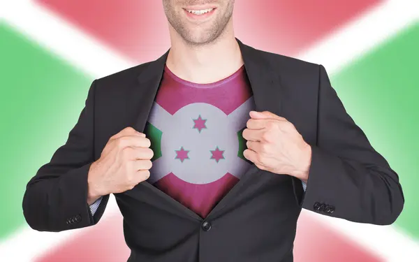 Zakenman opening pak te onthullen shirt met vlag — Stockfoto