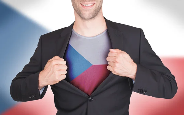 Hombre de negocios abriendo traje para revelar camisa con bandera — Foto de Stock