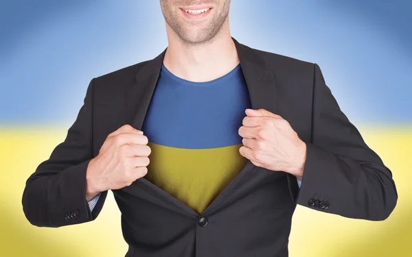 Businessman opening suit to reveal shirt with flag — Stock Photo, Image