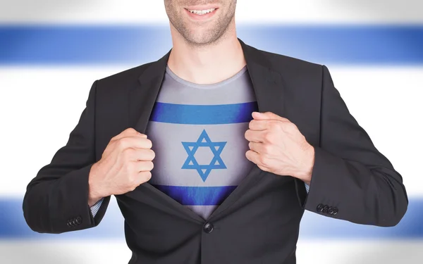 Hombre de negocios abriendo traje para revelar camisa con bandera — Foto de Stock