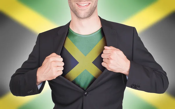 Businessman opening suit to reveal shirt with flag — Stock Photo, Image