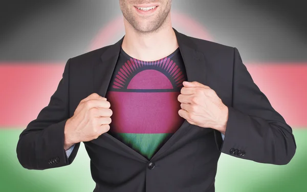 Businessman opening suit to reveal shirt with flag — Stock Photo, Image