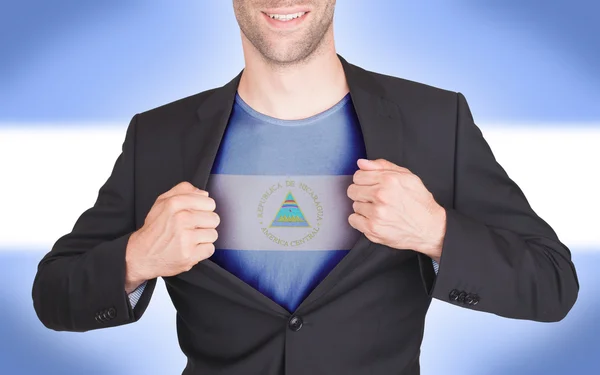 Hombre de negocios abriendo traje para revelar camisa con bandera —  Fotos de Stock