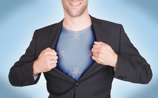 Businessman opening suit to reveal shirt with flag — Stock Photo, Image