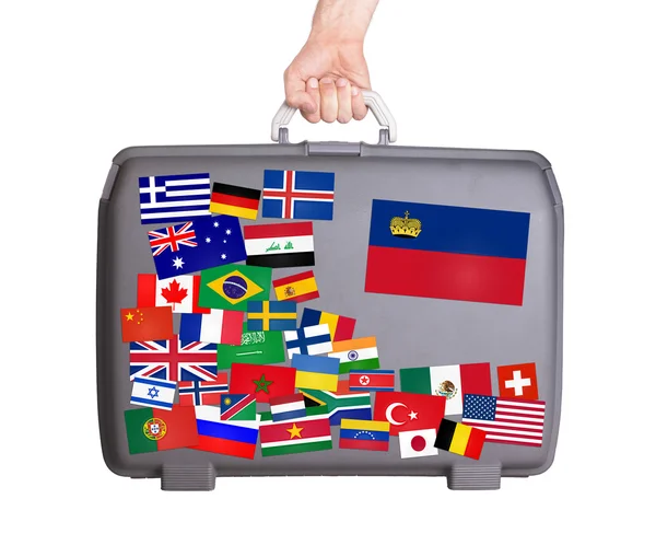 Used plastic suitcase with stickers — Stock Photo, Image