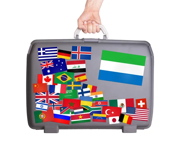 Used plastic suitcase with stickers — Stock Photo, Image