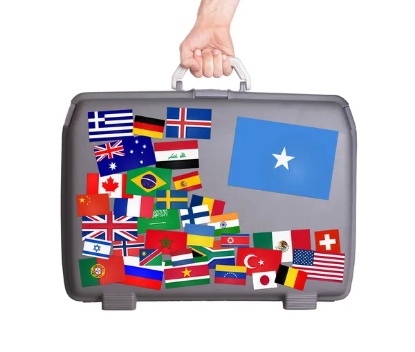 Used plastic suitcase with stickers — Stock Photo, Image