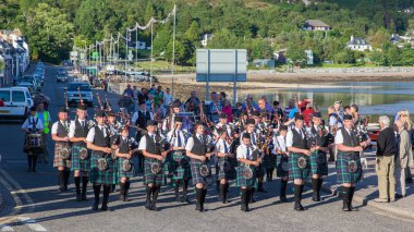 ULLAPOOL, SCOTLAND - JULY 17: Bagpipes' parade at local Highland clipart