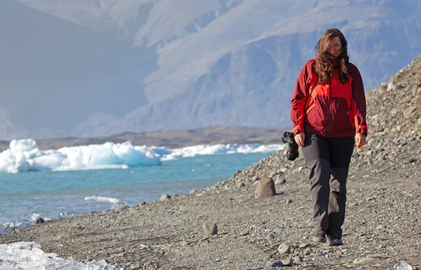 在冰岛南部 Jokulsarlon 冰川湖海滩走过的女人 — 图库照片