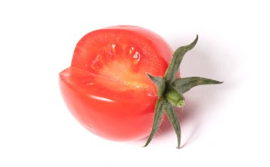 Small red tomato with a part cut out, isolated on white