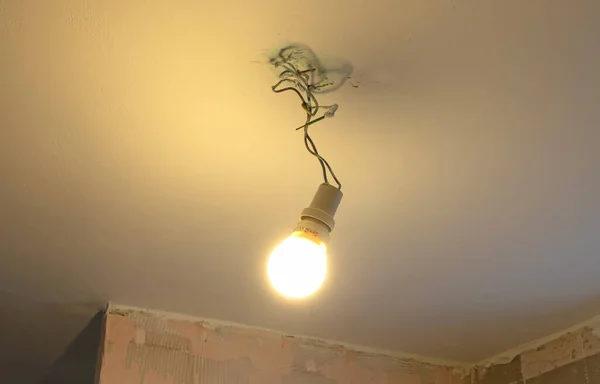 Lightbulb Hanging Temporarily Ceiling Bringing Light Darkness —  Fotos de Stock