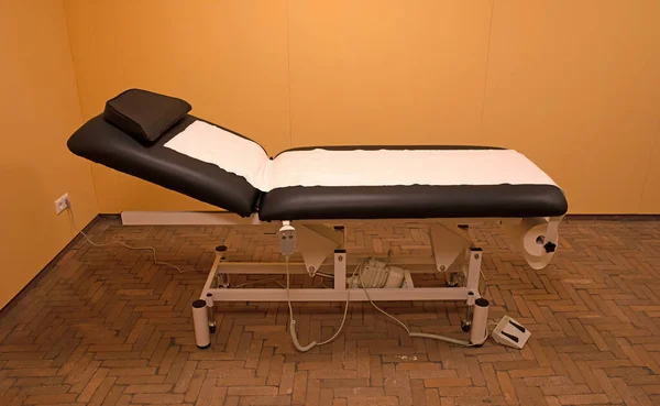 Examination room in a medical clinic, adjustable bed