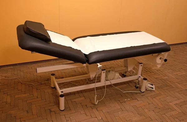 Examination room in a medical clinic, adjustable bed