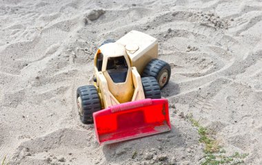 Dump truck toy working on the sand,.childrens toys