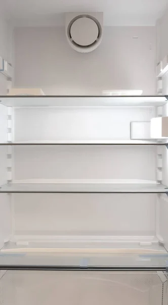Empty shelves in a fridge, selective focus