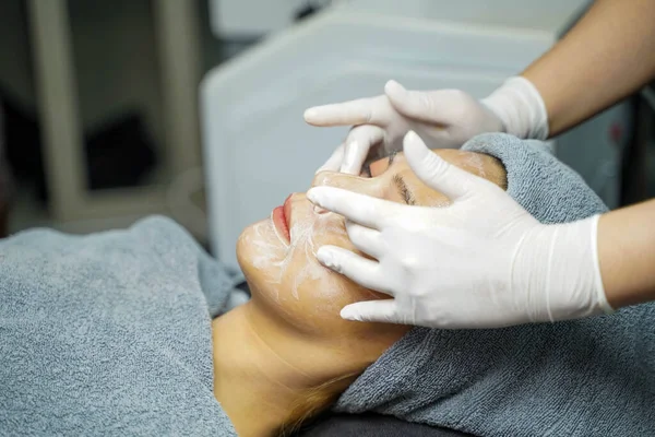 Closeup beauty woman making face spa and facial mask.