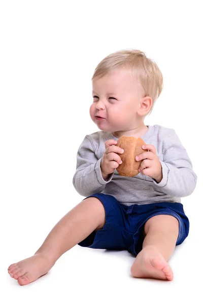 Baby eats bread — Stock Photo, Image